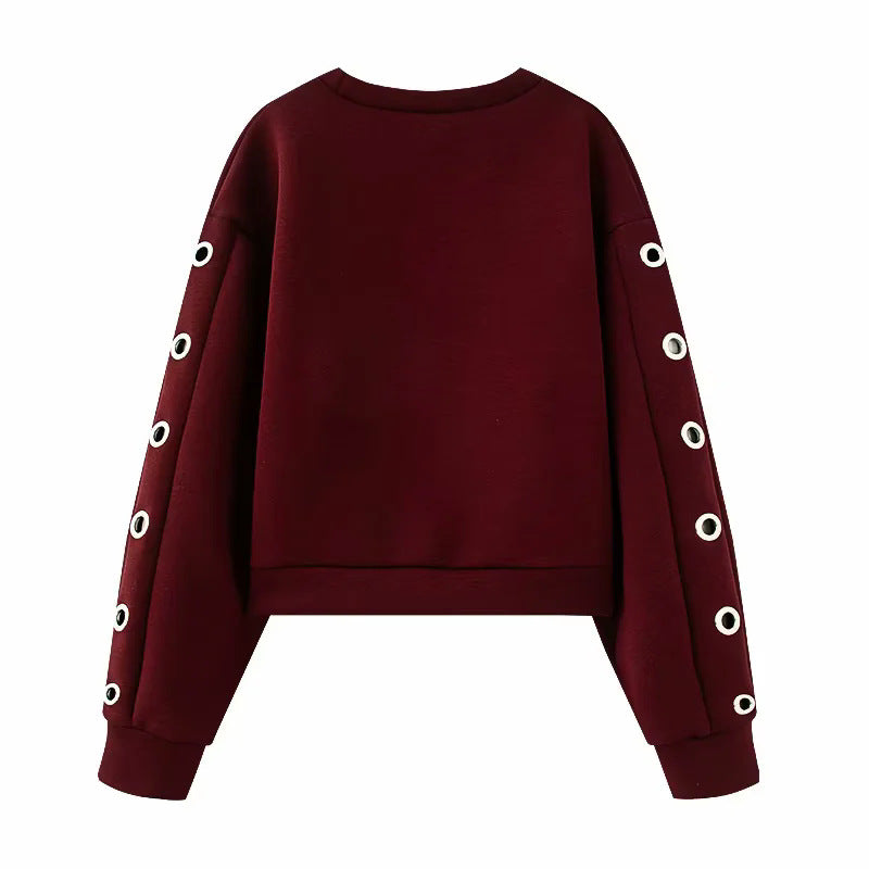 Women's oversized sweatshirt with decorative metal eyelets on the sleeves Mune Fashion