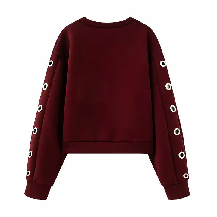 Women's oversized sweatshirt with decorative metal eyelets on the sleeves Mune Fashion