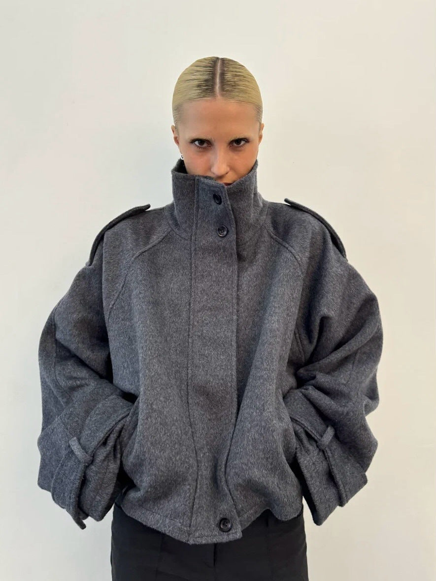 Ladies short cut oversized wool jacket with high stand-up collar, shoulder flaps and adjustable sleeve straps Mune Fashion