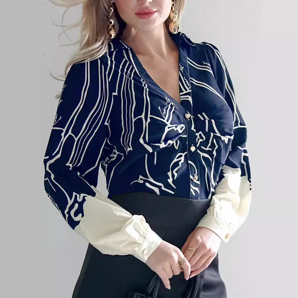 Women's V-neck blouse with abstract graphic print, balloon sleeves, and contrasting cuffs Mune Fashion