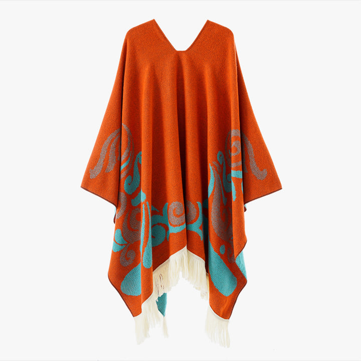 Women's wool blend poncho in cape style with V-neck, contrasting ornament jacquard and fringes.