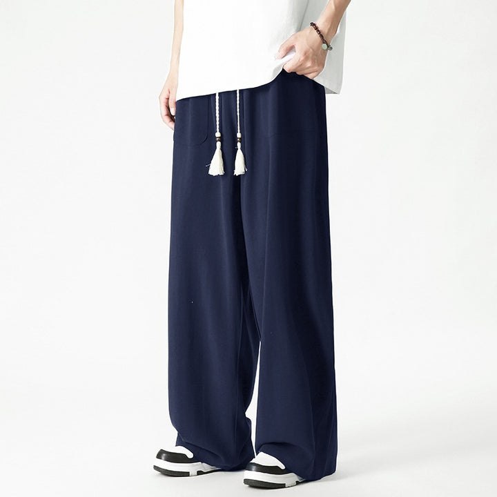 Men's loose-fitting lounge pants with tassel cord, elastic waistband, and patch pockets Mune Fashion