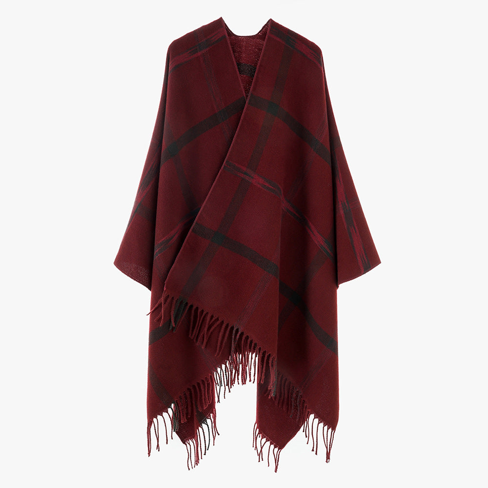 Women's large checkered wool look poncho in cape cut with loose drape and fringes.