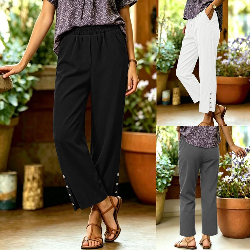 Women's loosely cut high-waist leisure pants with elastic waistband and decorative snap button placket on the leg Mune Fashion