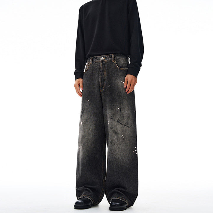 Men's loosely cut denim pants in floor-length baggy style with subtle paint splatter look Mune Fashion