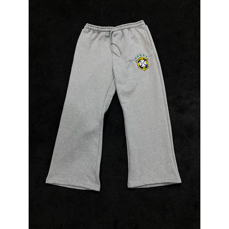 Women's loose jogging pants with elastic waistband, drawstring, and embroidered emblem Mune Fashion