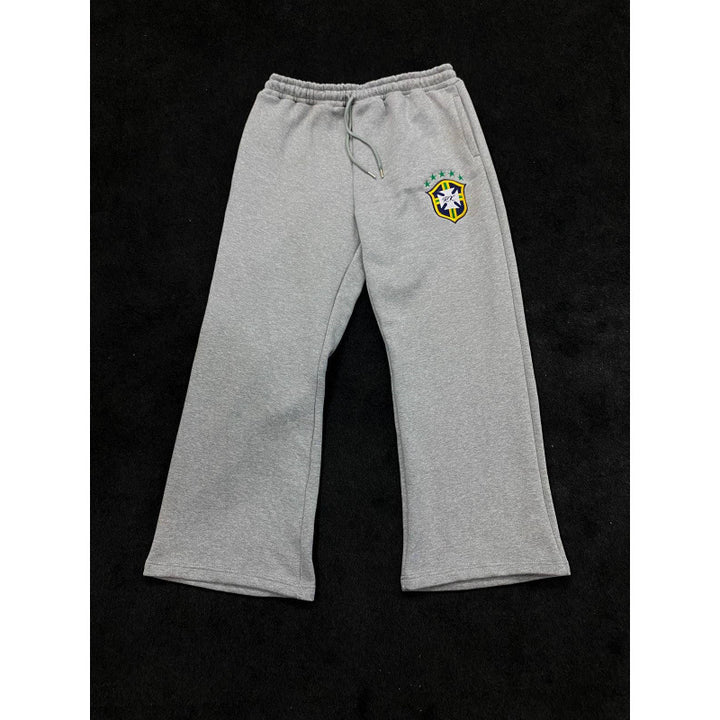 Women's loose jogging pants with elastic waistband, drawstring, and embroidered emblem Mune Fashion