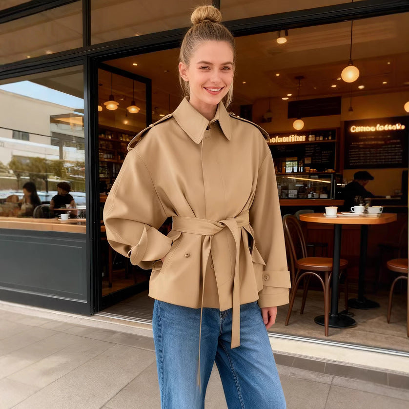 Women's short trench coat with waist belt, shoulder flaps, and patch pockets Mune Fashion