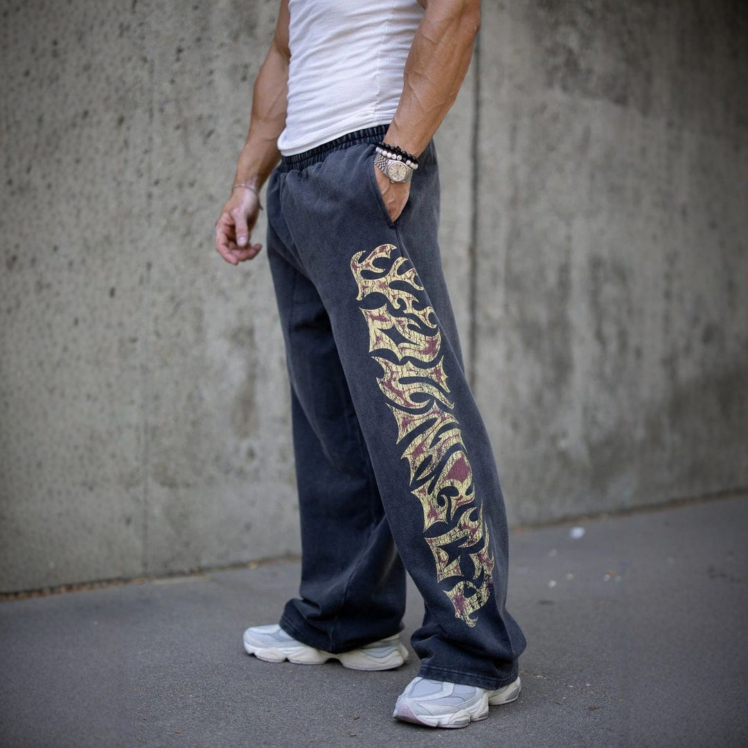 Men's baggy joggers with elastic waistband, side pockets and detailed skull and rose motif Mune Fashion