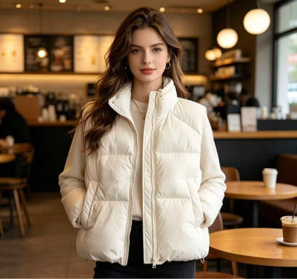 Women's short padded puffer jacket with high stand-up collar and practical side pockets Mune Fashion