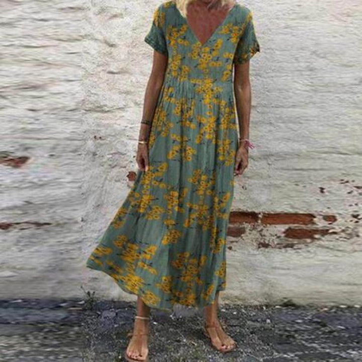 Women’s V-neck maxi dress with fine pleated skirt, empire bodice and short sleeves Mune Fashion