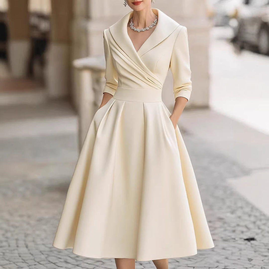 Women's elegant midi dress with wrap top, three-quarter sleeves, and side pockets Mune Fashion