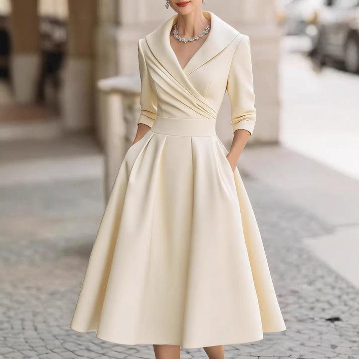 Women's elegant midi dress with wrap top, three-quarter sleeves, and side pockets Mune Fashion
