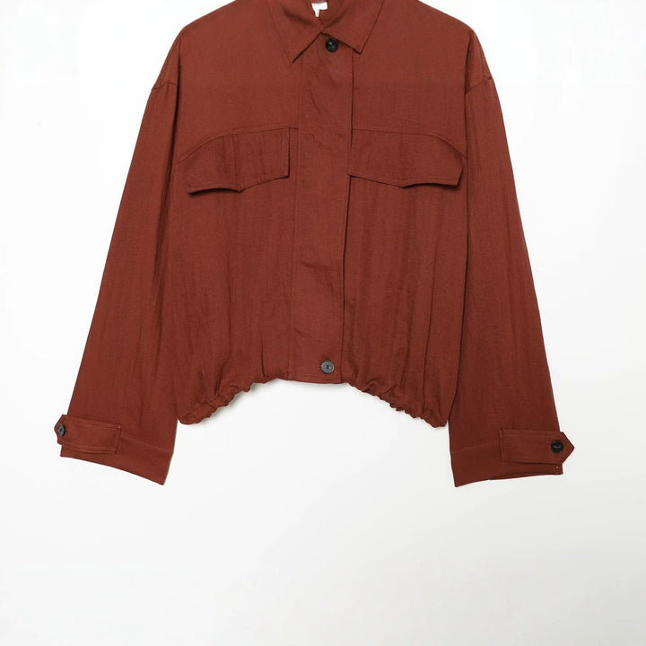 Women's short jacket in utility style with stand-up collar, patch chest pockets, and drawstring hem Mune Fashion