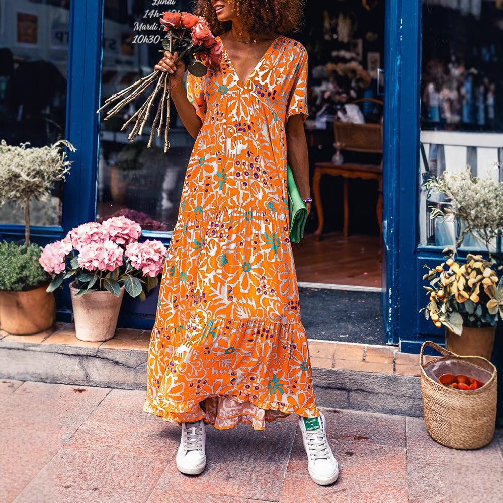 Women’s ankle-length V-neck maxi dress with graphic ethnic print, short sleeves and flared ruffle hem Mune Fashion