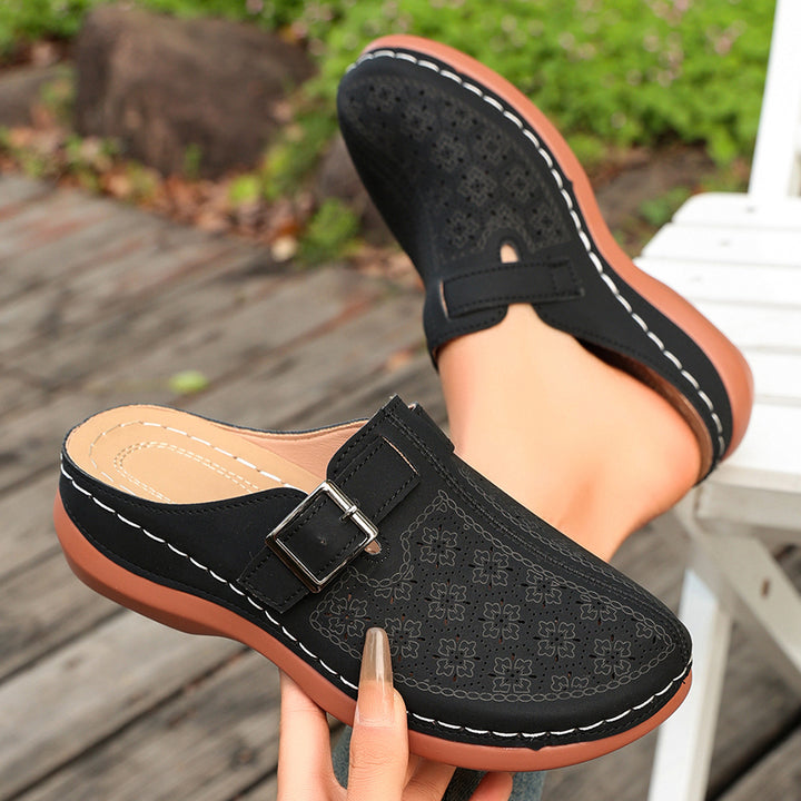 Women's comfort mule with adjustable buckled strap and ornamental hole embossing Mune Fashion