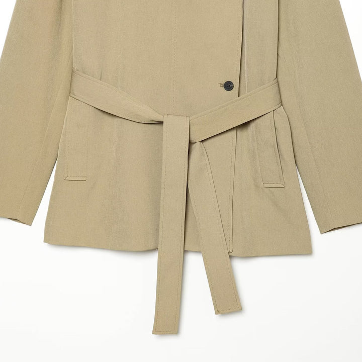 Women's short trench coat in lightweight gabardine style with asymmetrical button closure and tie belt Mune Fashion