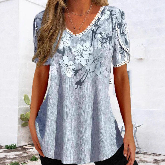Women's flowing V-neck tunic top with floral print pompom trim and A-line cut Mune Fashion