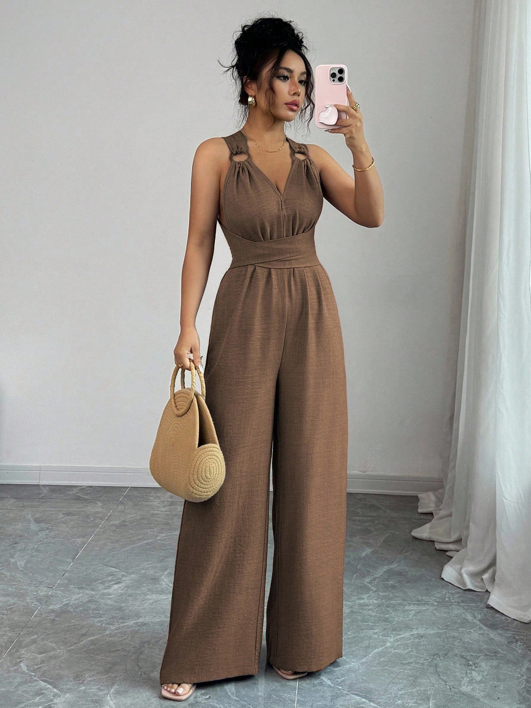 Women’s jumpsuit with wide leg, tailored wrap belt and eyelet straps Mune Fashion