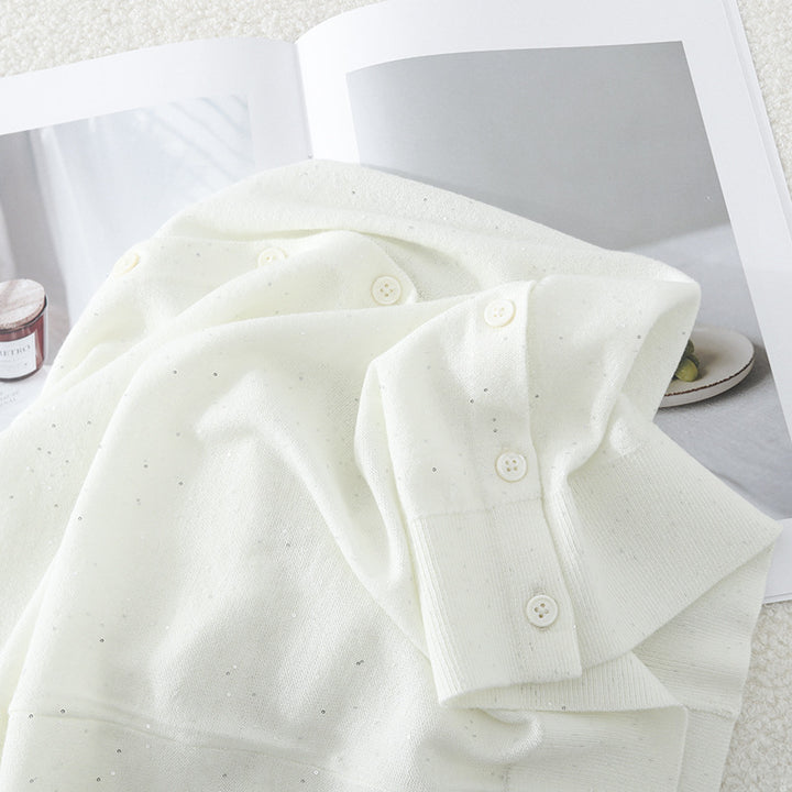 Women's fine round neck cardigan made of lightweight fine knit with pearl button placket and subtle glitter effect.