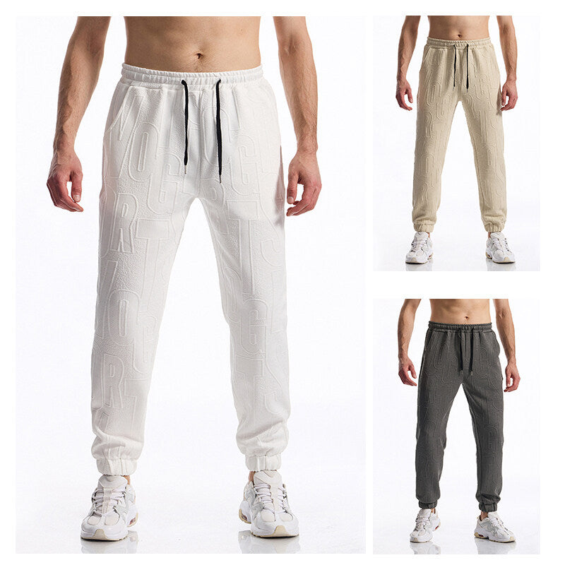 Men's jogging pants with elastic waistband, drawstring, and embossed all-over logo relief Mune Fashion