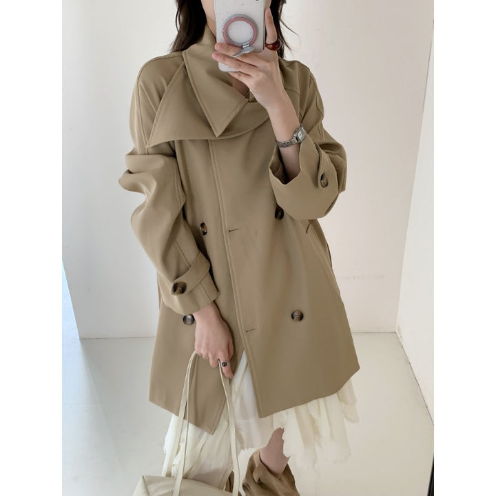 Women’s short trench coat with extra wide lapels, raglan sleeves, and horn button details Mune Fashion