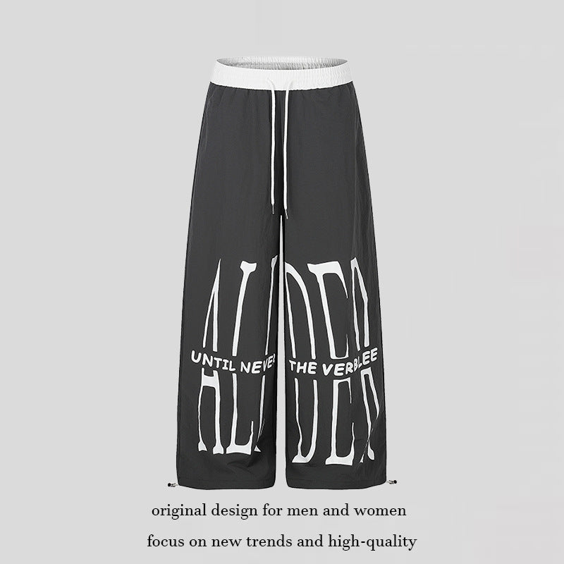 Women's wide loungewear pants with high comfort waistband, drawstring, adjustable hem, and typographic print Mune Fashion