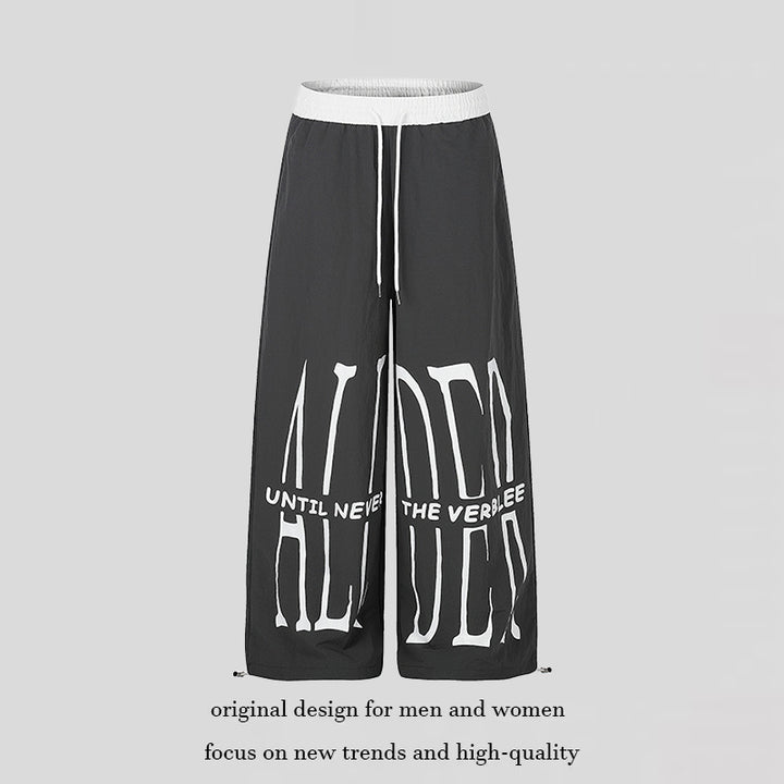 Women's wide loungewear pants with high comfort waistband, drawstring, adjustable hem, and typographic print Mune Fashion