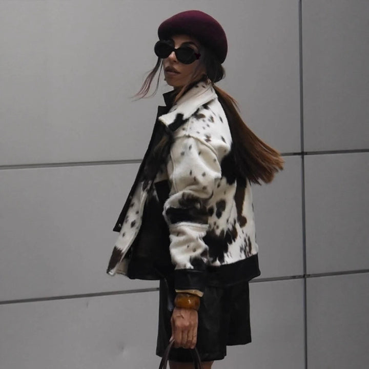 Women short padded biker jacket made of faux fur in cow print with contrast leather trim Mune Fashion