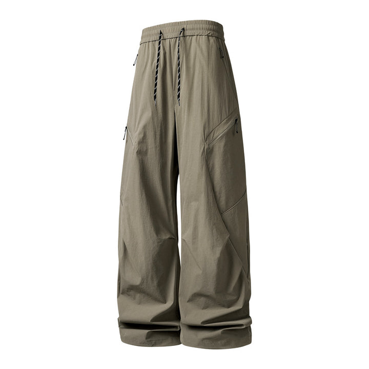Men's Oversize Utility Cargo Pants made of lightweight nylon with elastic drawstring waistband, side zipper pockets & wide balloon silhouette Mune Fashion