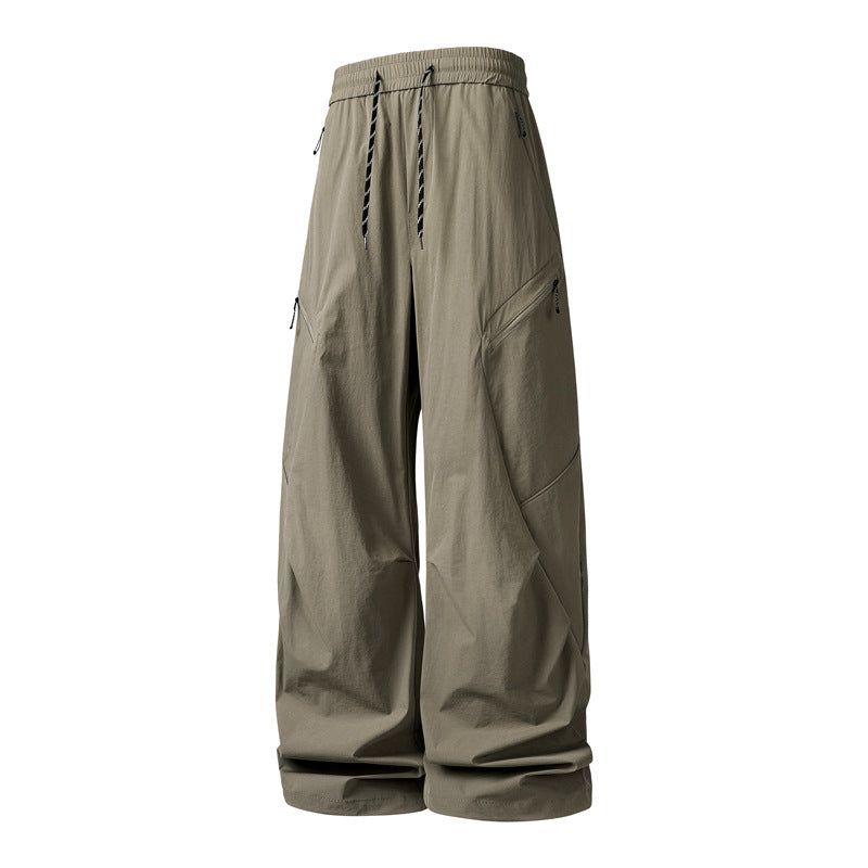Men's Oversize Utility Cargo Pants made of lightweight nylon with elastic drawstring waistband, side zipper pockets & wide balloon silhouette Mune Fashion
