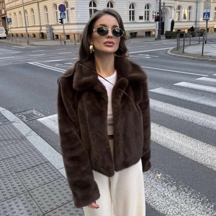 Women's short-cut vegan faux fur jacket with wide lapel collar and concealed snap-button placket Mune Fashion