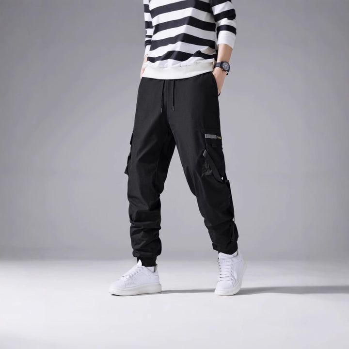 Men's tapered utility cargo pants in jogger style with multiple pockets, drawstring & elastic ankle cuffs Mune Fashion