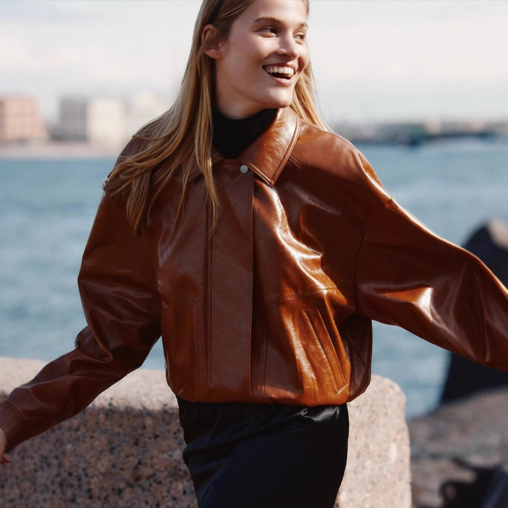 Women's short blazer made of vegan smooth leather with boxy silhouette and concealed snap button placket Mune Fashion