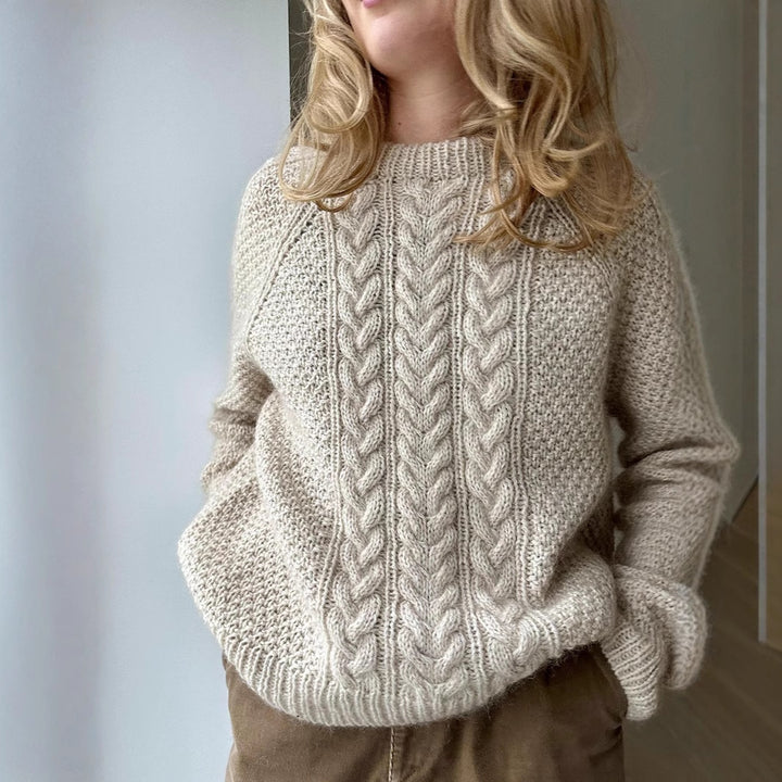 Women's oversized knitted sweater with cable pattern