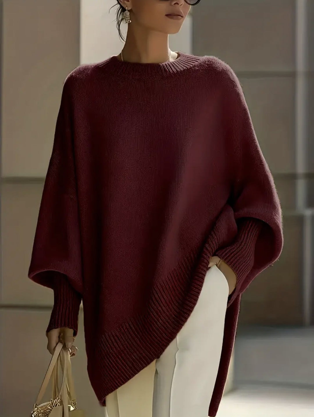 Women's oversized knit poncho with asymmetrical hem and ribbed sleeves Mune Fashion