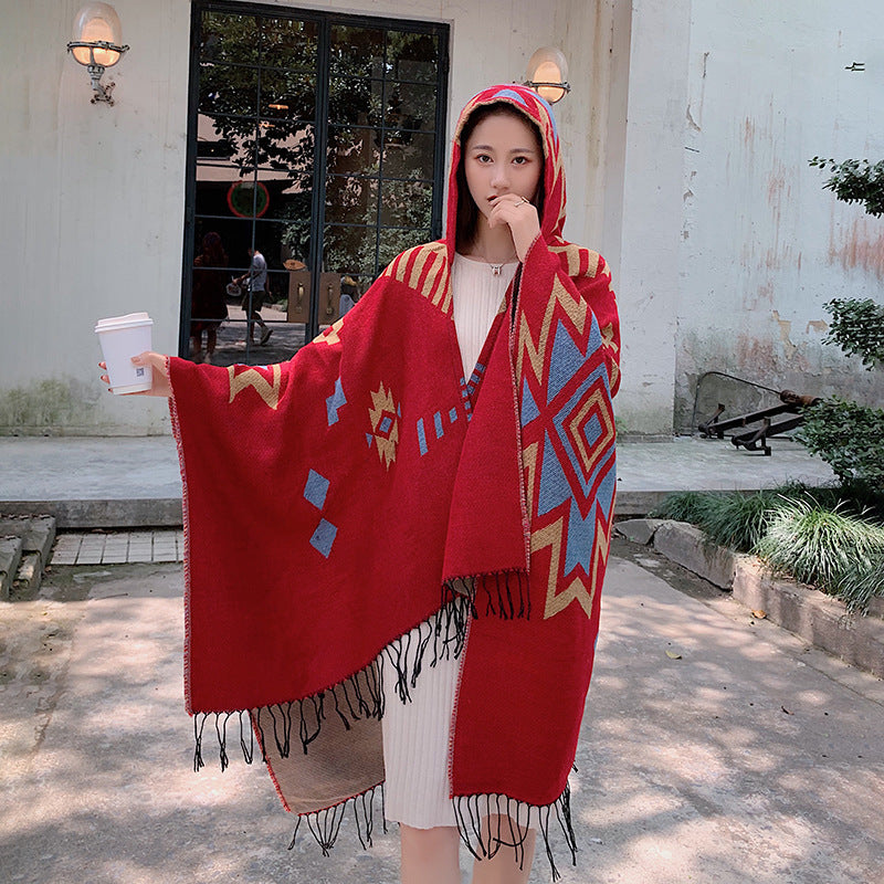 Women's oversized knitted hooded poncho in ethnic jacquard with fringe hem Mune Fashion
