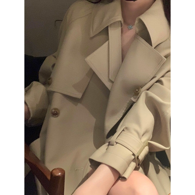 Women's elegant midi trench coat with oversized shoulder flap, gathered sleeves, and waist-defining tie belt Mune Fashion