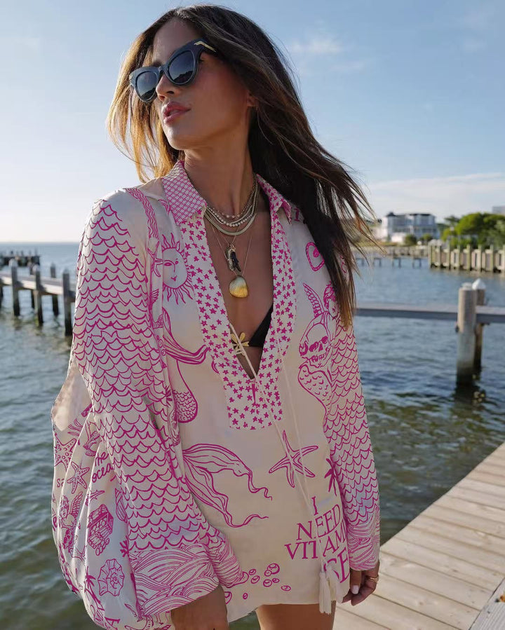 Ladies lightweight beach cover-up in tunic form with deep V-neck, tassel closure, and nautical ocean print Mune Fashion