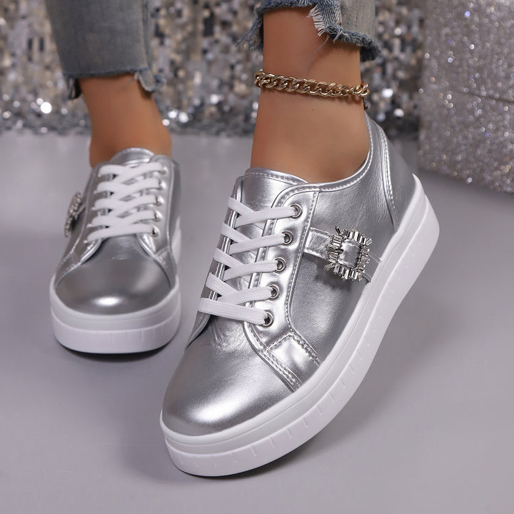 Ladies' platform sneaker with metallic upper material, decorative rhinestone buckle, and padded comfort sole Mune Fashion