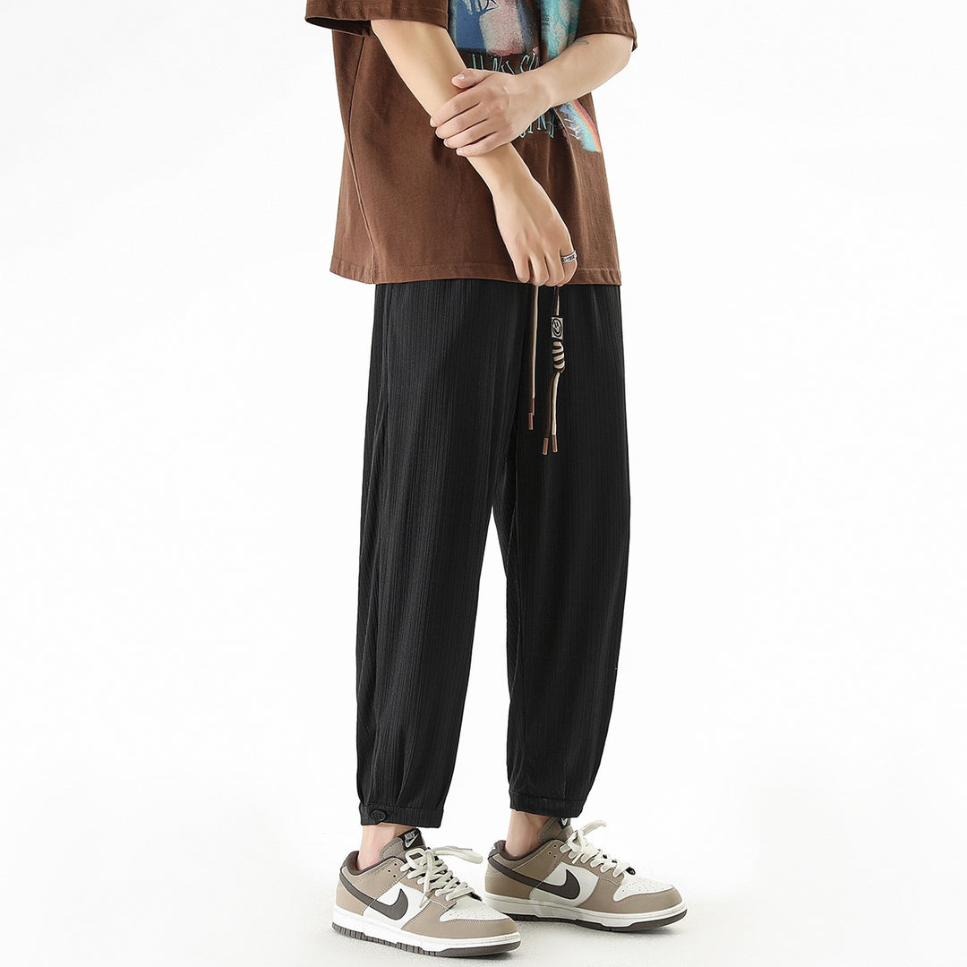 Men's loose-fitting leisure pants with drawstring, fine ribbed structure, and buttoned cuffs Mune Fashion