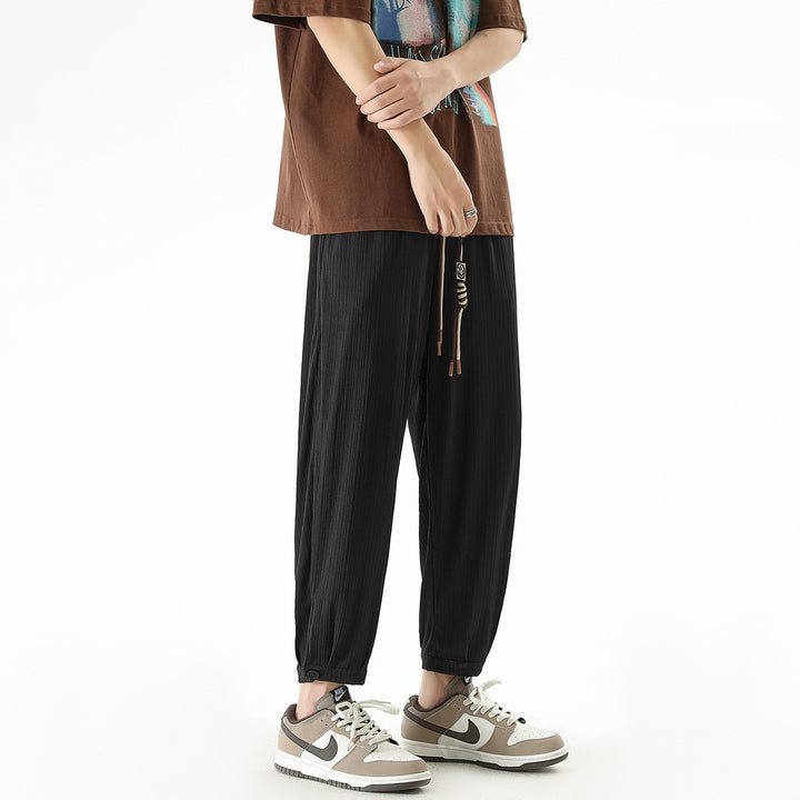 Men's loose-fitting leisure pants with drawstring, fine ribbed structure, and buttoned cuffs Mune Fashion