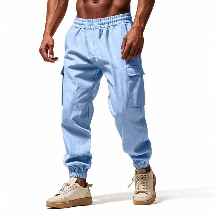 Men's tapered joggers in utilitarian style with elastic waistband, drawstring, and flap pockets Mune Fashion