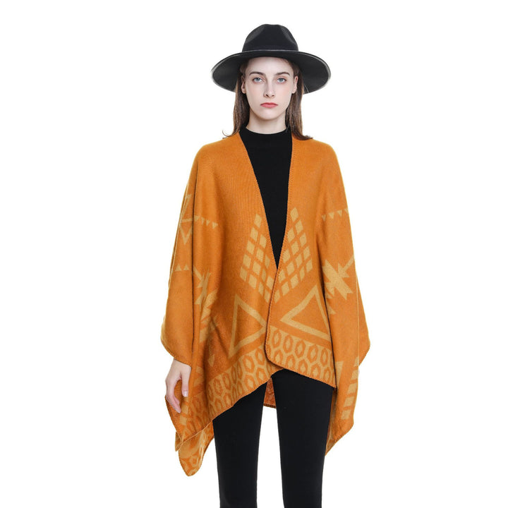 Women's oversized Ruana poncho with cashmere touch, geometric jacquard, and open kimono silhouette.