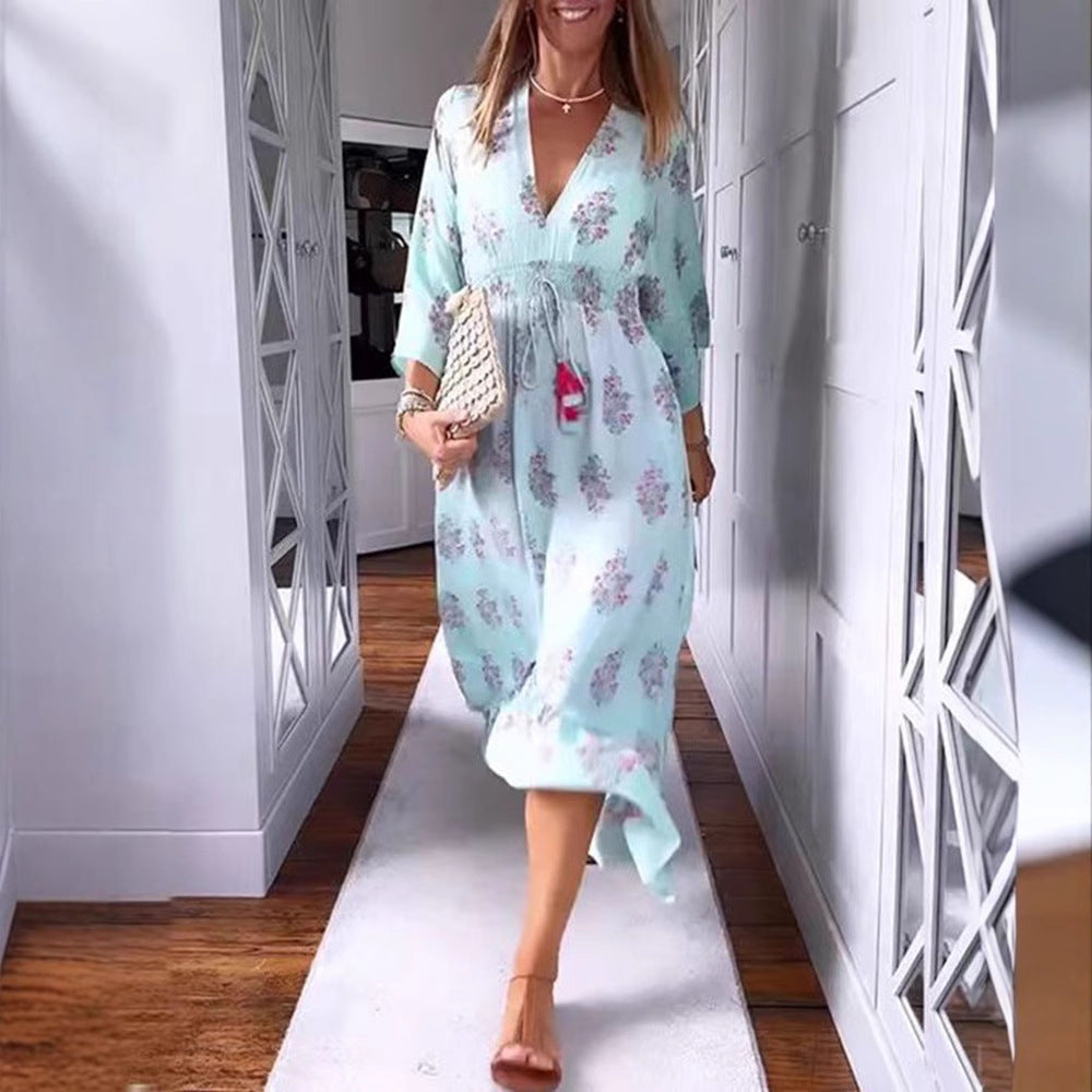 Women’s airy-flowing Boho midi dress with V-neck, gathered smock waist, drawstring with tassels, and asymmetrical ruffled hem Mune Fashion