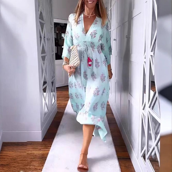 Women’s airy-flowing Boho midi dress with V-neck, gathered smock waist, drawstring with tassels, and asymmetrical ruffled hem Mune Fashion