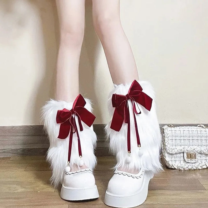 Ladies cozy boot cuffs made of faux fur with bow appliqué and pompons Mune Fashion
