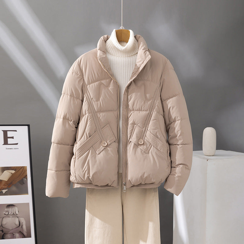 Women's nan short quilted jacket with high collar trim, diagonally placed decorative seams and flap pockets Mune Fashion