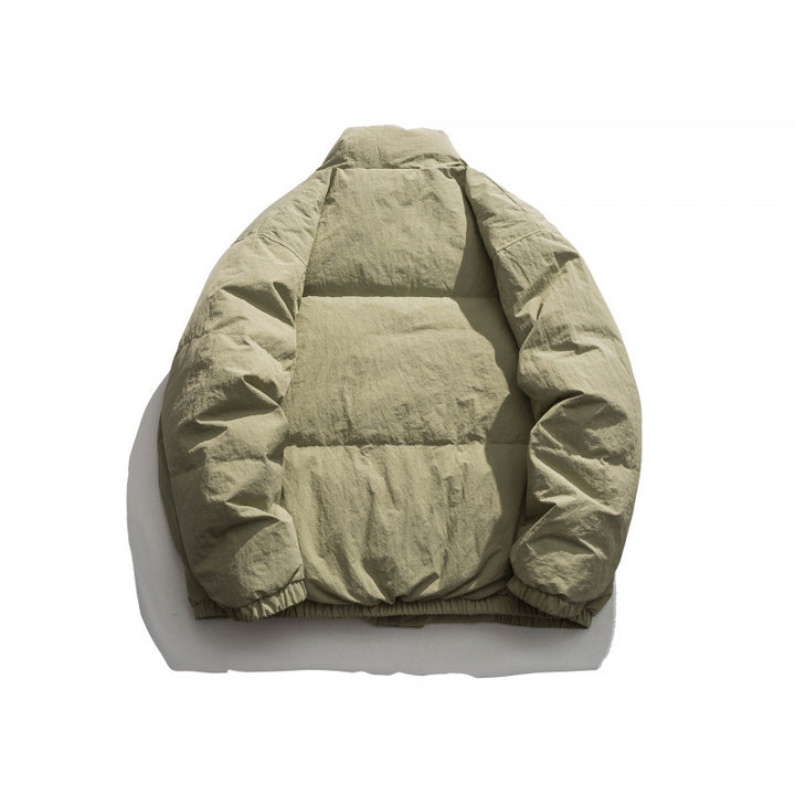 Unisex Oversized padded quilted jacket with high stand collar, large flap pockets and crinkle effect Mune Fashion