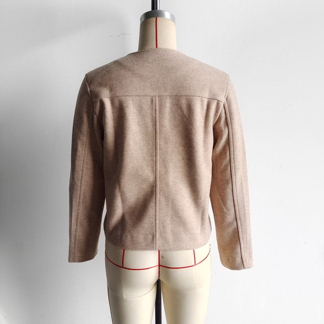 Women's structured short jacket with round neck, breast pockets, and decorative metal button strip Mune Fashion
